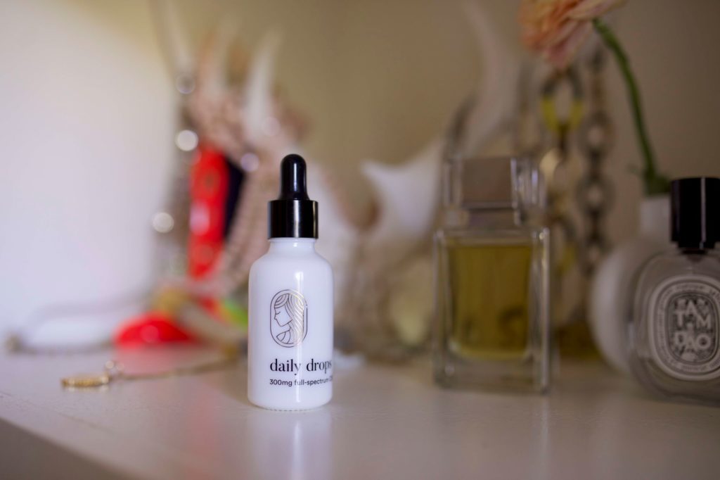 Bottle of Equilibria Daily Drops on vanity.