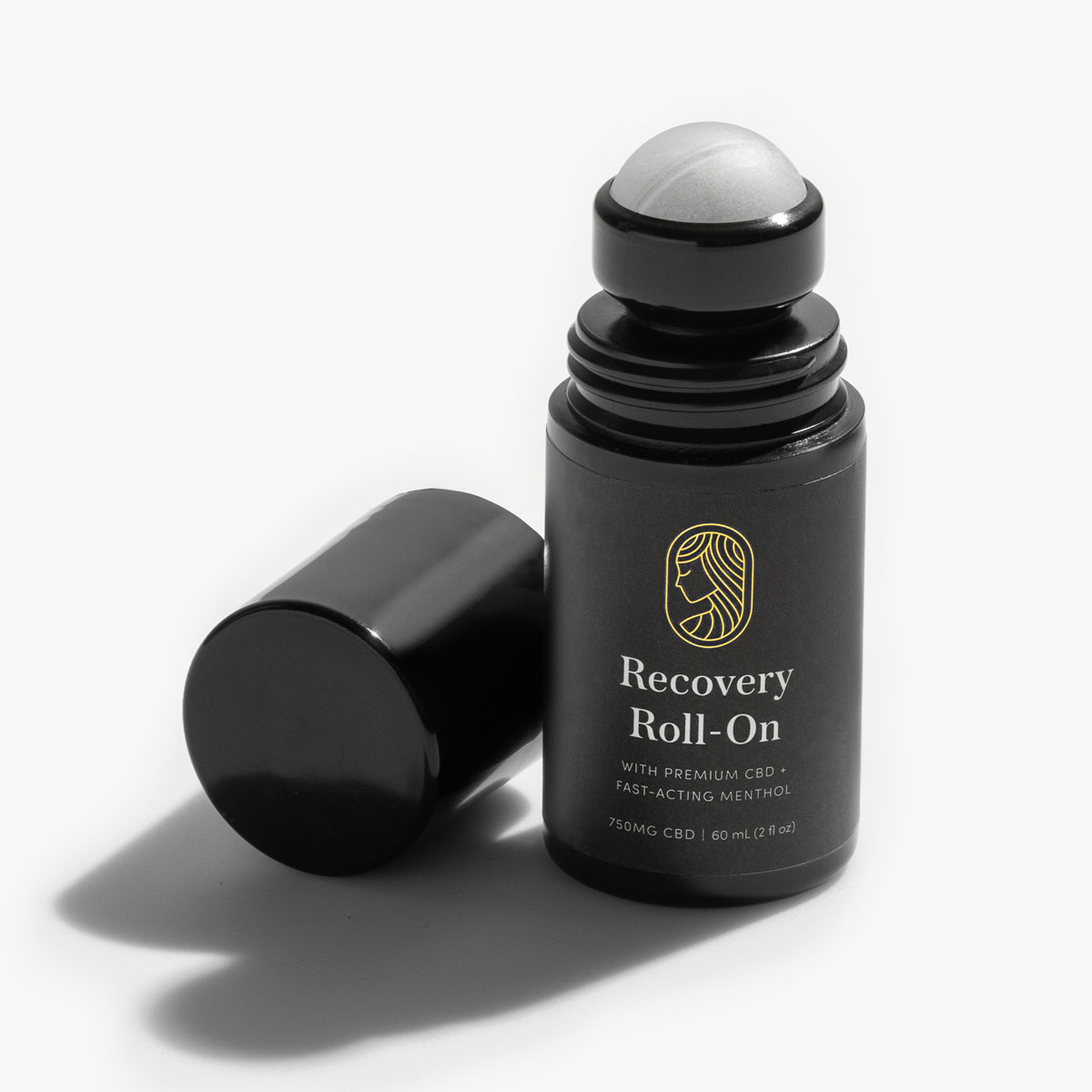 Black Recovery Roll-On container with lid off on black background.